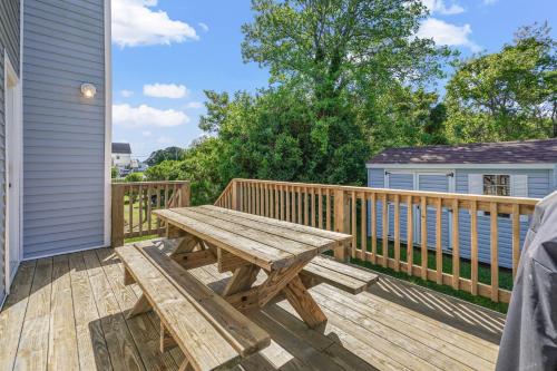 a wooden deck with a wooden picnic table on a house at Olive Ponies - Upper level with water Views! in Birch Town