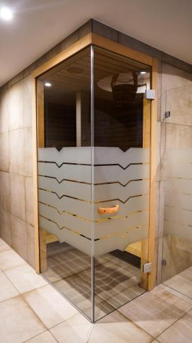 a glass shower door in a room with at DAS KEHRS - Hotel auf dem Petersberg in Erfurt