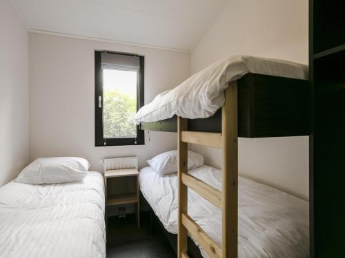 two bunk beds in a small room with a window at Chalet in Zell am See near Ski Slope in Markelo
