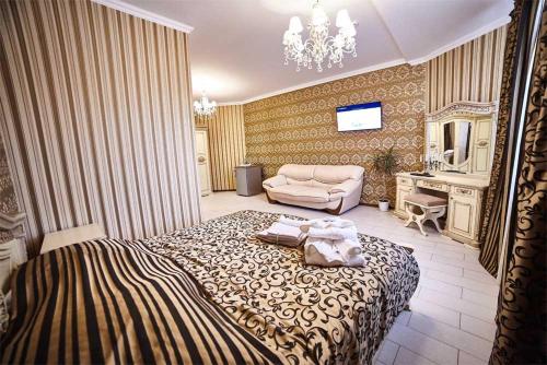 a bedroom with a large bed and a couch at Hotel Kristall in Kislovodsk