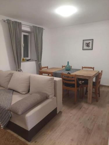a living room with a couch and a table at House Dalmatika Zaton in Zaton