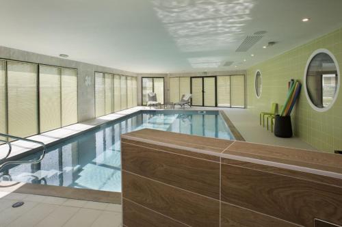 a large swimming pool in a building at DOMITYS - Le Pupitre d'Or in Saint-James