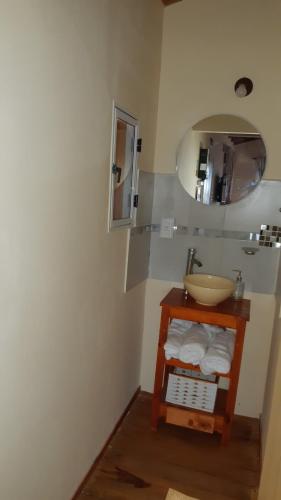 a bathroom with a sink and a mirror at Las Secretas in La Cumbre