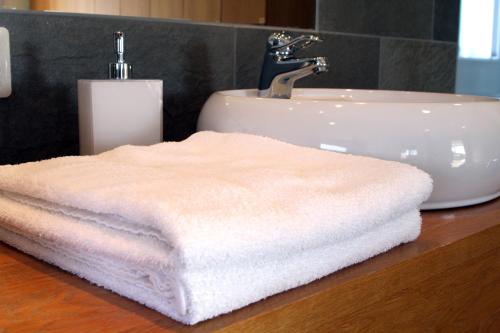 a white towel sitting on a counter next to a sink at Sand Golf Club in Bankeryd
