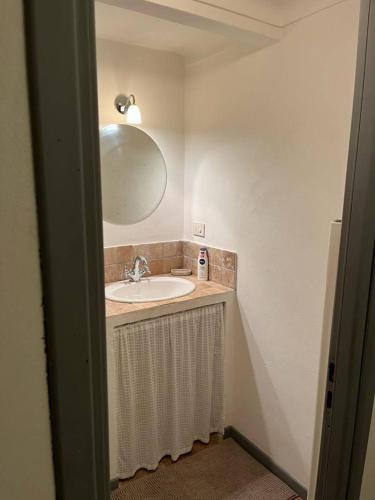 a bathroom with a sink and a mirror at Casale in campagna ristrutturato in Apricale