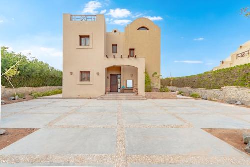a building with a stone driveway in front of it at Dream Beach House on Island 3BR Priv Pool Sabina El Gouna in Hurghada