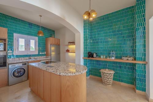 a kitchen with green tiled walls and a counter top at Dream Beach House on Island 3BR Priv Pool Sabina El Gouna in Hurghada