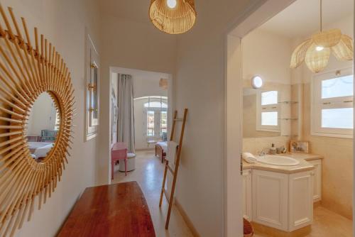 a bathroom with a mirror and a sink at Dream Beach House on Island 3BR Priv Pool Sabina El Gouna in Hurghada