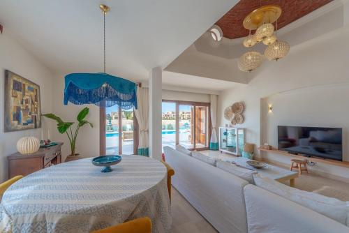 a living room with a table and a couch at Dream Beach House on Island 3BR Priv Pool Sabina El Gouna in Hurghada