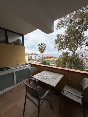 a balcony with a table and chairs and a sink at Bonocore Accomodation in Tropea