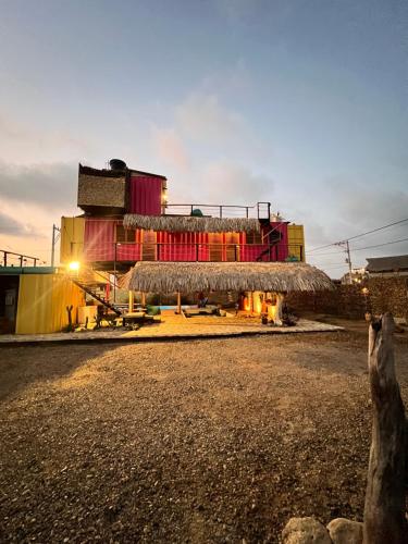 a large building with a roof on the side of a road at WIND Loft en Mojarra Beach in Salina de Rey