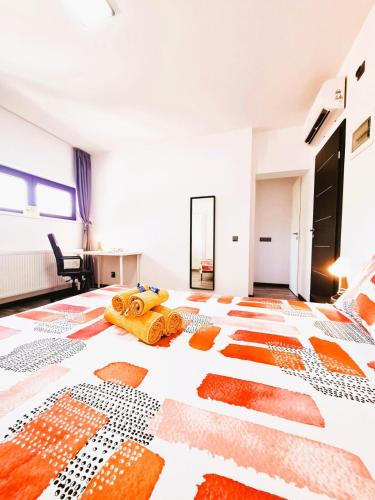 a bedroom with a bed with an orange and white floor at Old Town Retreat Studio 9 in Bucharest