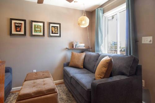 a living room with a blue couch and a window at Folly Ha I in Folly Beach