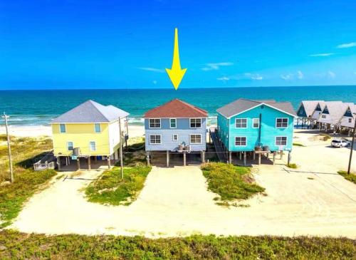 a row of houses on the beach with a yellow arrow at Starfish Beachfront Swim-Up in Surfside Beach