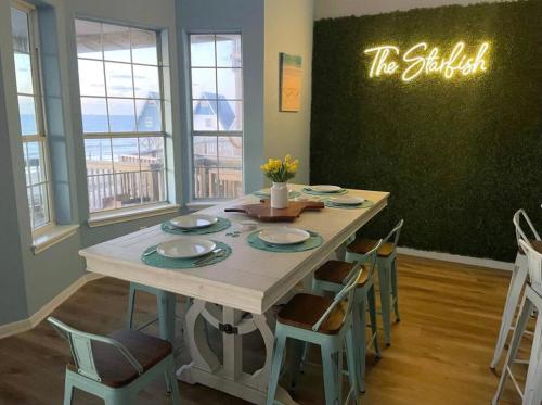 a dining room table with chairs and a sign that reads the buffet at Starfish Beachfront Swim-Up in Surfside Beach