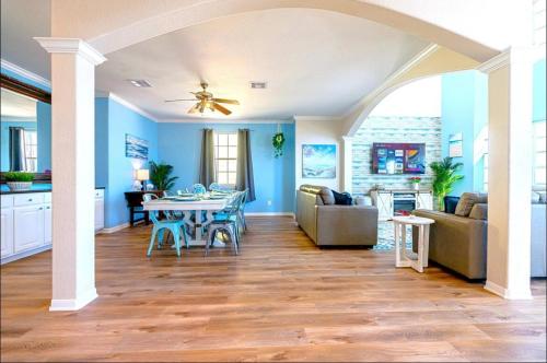 a living room with blue walls and a table at Starfish Beachfront Swim-Up in Surfside Beach