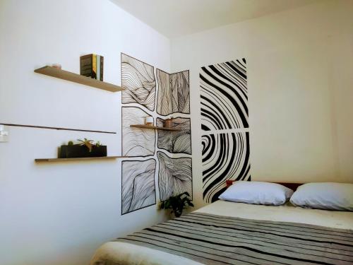 a bedroom with a bed with a drawing on the wall at Magnífica habitación rodeada de arte en Centro Histórico in Mexico City