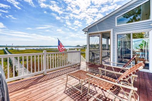 a patio with two chairs and a table on a deck at Return - Waterfront with boat dock! in Black Point Landing
