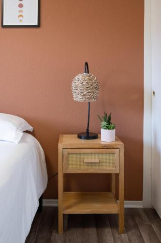 a lamp on a night stand next to a bed at Grand Desert Oasis - SPA - A Location - JT Park in Joshua Tree