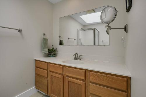 a bathroom with a sink and a mirror at Poole's Cove - Waterfront; Main Street! in Deep Hole
