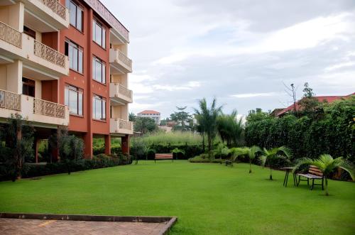 a large lawn in front of a building at Brand New Condo Apartment in Kampala