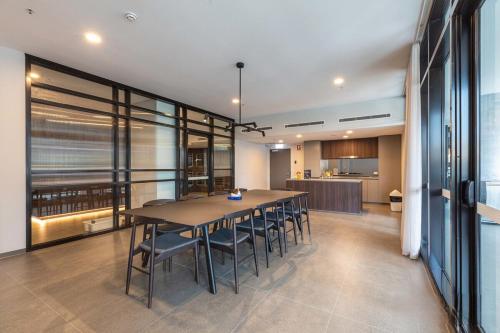 a large dining room with a table and chairs at Luxurious Cozy 1-Bed FREE Carpark Gym Pool & Spa in Belconnen