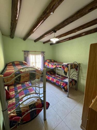a room with two bunk beds and a window at Duplex Aconcagua in Guaymallen