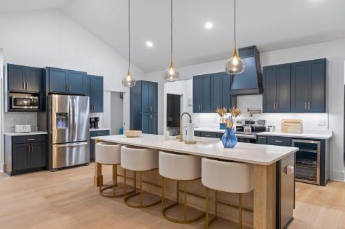 a kitchen with blue cabinets and a kitchen island with white counter tops at Serene Canal Escape - Heated Pool, Private Dock, Game Room in Palm Coast