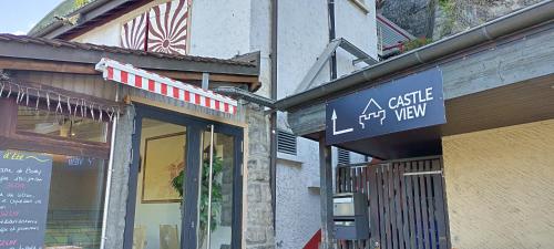 a building with a sign for a cafe left way at Castle view by MK in Montreux