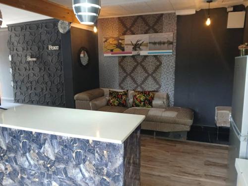 a living room with a couch and a table at Urban Villa 25 in Gaborone