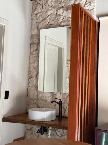 a bathroom with a sink and a mirror at Villa Dois Amores in Lindóia