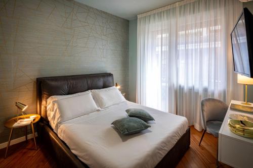 a bedroom with a bed with two pillows on it at Sky Blue Rooms in Bastia Umbra