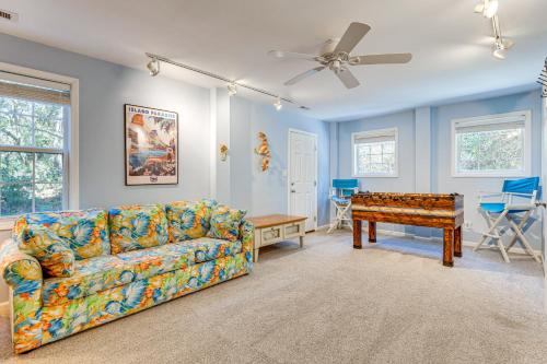 a living room with a couch and a table at Steps to Beach Emerald Isle Home with Deck! in Emerald Isle