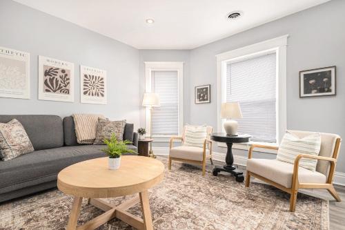 a living room with a couch and chairs and a table at Remodeled Washer Dryer Mins to Beach & Downtown in Michigan City