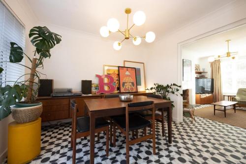 a dining room with a table with a letter b on it at Cosy mid century Stockport with views, dog walks, woodburner in Woodley