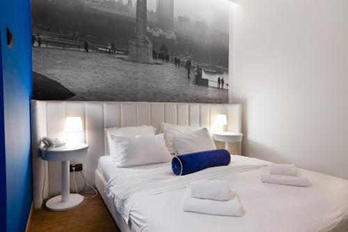 Un ou plusieurs lits dans un hébergement de l'établissement Hotel Passport