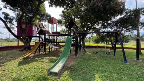 a playground with a slide in a park at Quinta mi Antojo in Acacías