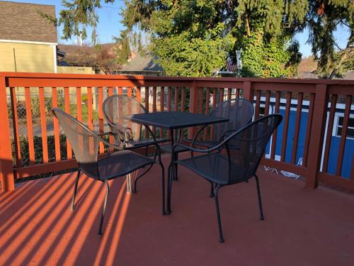 a table and four chairs on a deck at Rainier Entire Upper Floor - Walk to Metro in Seattle