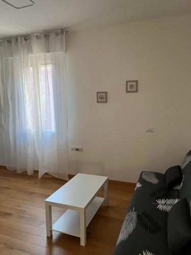 a living room with a couch and a coffee table at Appartamento Liguria5 in Bologna