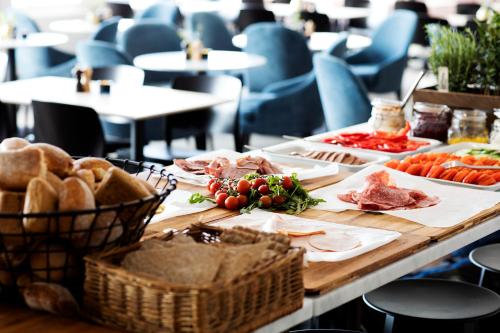 a table with food on it with bread and meats at Welcome Hotel Barkarby in Järfälla