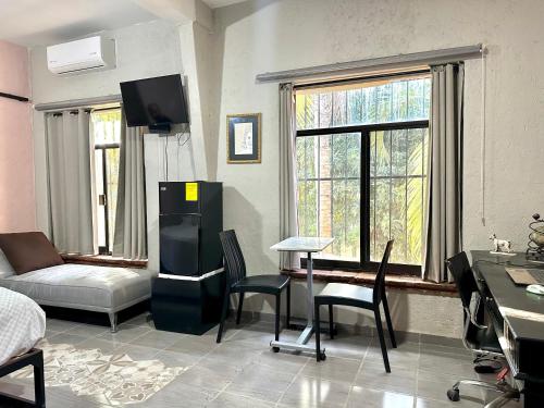 sala de estar con nevera, mesa y sillas en Casa Dos Antonios en Zona Viva de Puerto Vallarta, en Puerto Vallarta