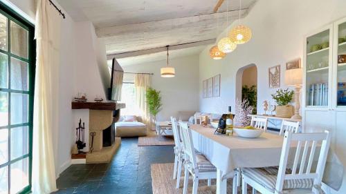 a dining room and living room with a table and chairs at The Cliffs - Vue de Pantin in Valdoviño