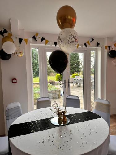 a room with a table with balloons on the wall at Broom Hall Country Hotel in Saham Toney