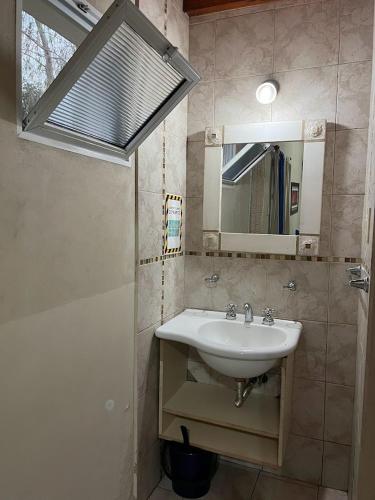 a bathroom with a sink and a mirror at Costa Luna Federacion in Federación