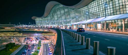 a large building with a lot of traffic at night at Top House Zayed Airport in Abu Dhabi