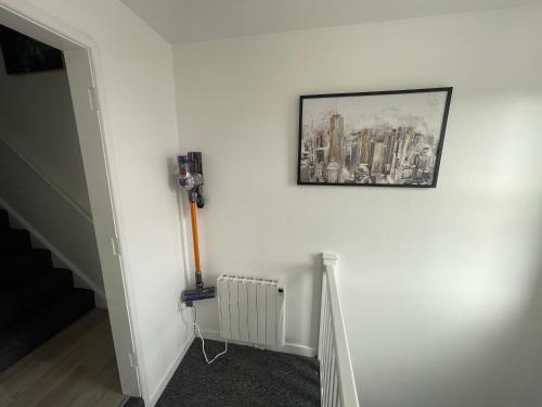 a room with a picture on a wall with a radiator at welcome rooms 47A in Swindon