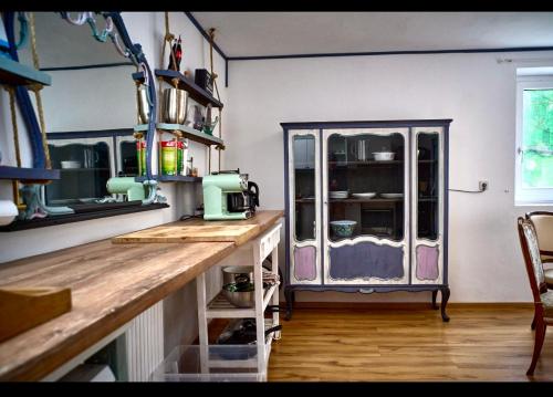 a kitchen with a counter and a glass cabinet at Schöne Gartenwohnung in Salzburg