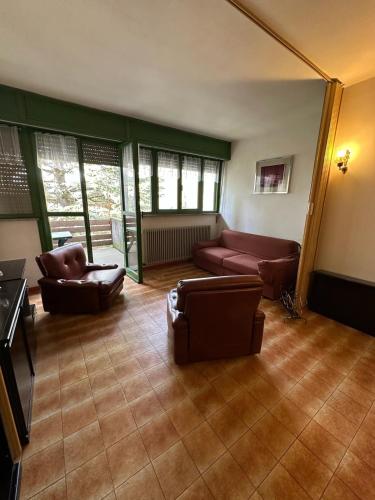 a living room with two chairs and a couch at Trilocale Prealpi in Margno