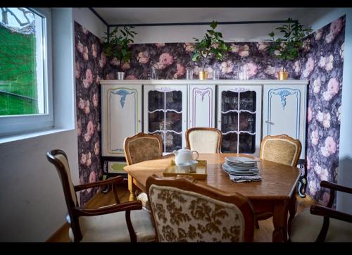 a dining room with a wooden table and chairs at Schöne Gartenwohnung in Salzburg