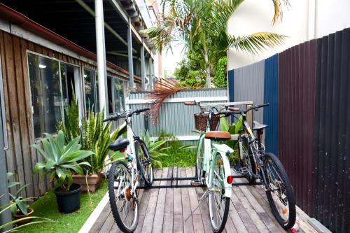 two bikes are parked next to a building at City Backpackers HQ in Brisbane